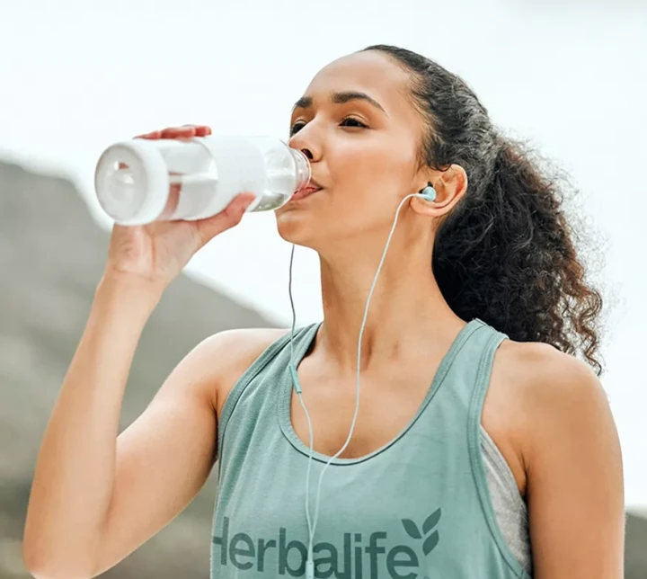 li-woman-drinking-water-outside.webp